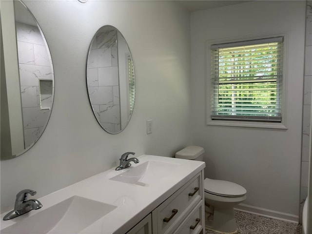 bathroom featuring a sink, toilet, and double vanity