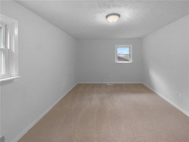 6389 Cumberland Dr, Rex, GA 30273 - spare room featuring baseboards, light carpet, and a textured ceiling