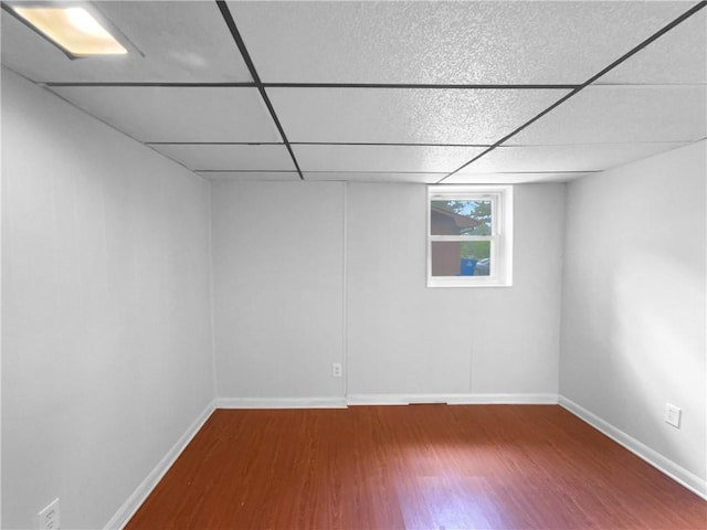 6389 Cumberland Dr, Rex, GA 30273 - below grade area featuring wood finished floors, a drop ceiling, and baseboards