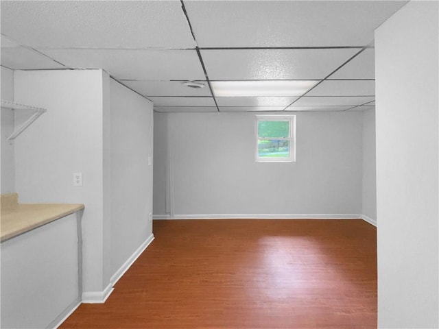 6389 Cumberland Dr, Rex, GA 30273 - basement with wood finished floors, a paneled ceiling, and baseboards