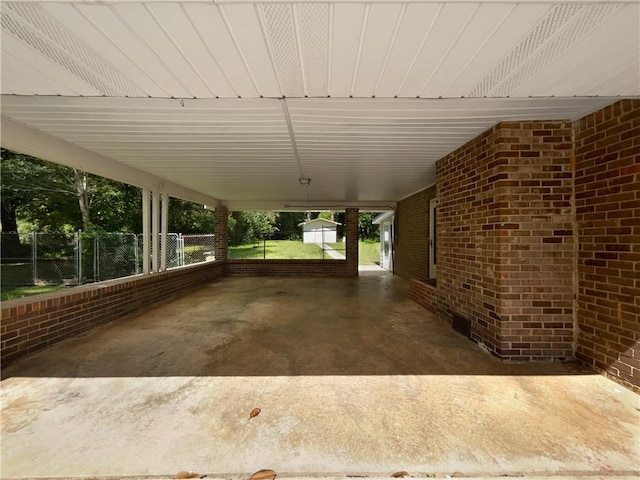 6389 Cumberland Dr, Rex, GA 30273 - view of patio featuring fence, an attached carport, and an outbuilding