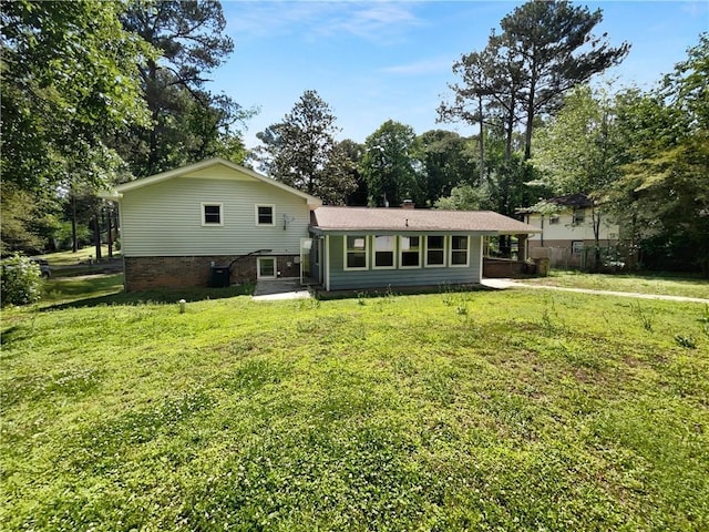 6389 Cumberland Dr, Rex, GA 30273 - back of property featuring a yard