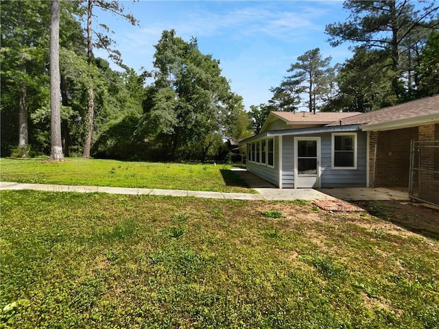 6389 Cumberland Dr, Rex, GA 30273 - view of green lawn featuring a patio
