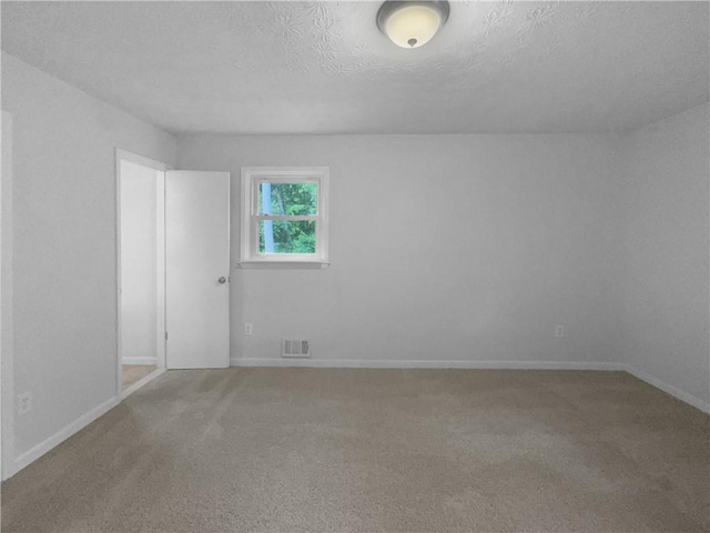 6389 Cumberland Dr, Rex, GA 30273 - carpeted spare room with a textured ceiling and baseboards