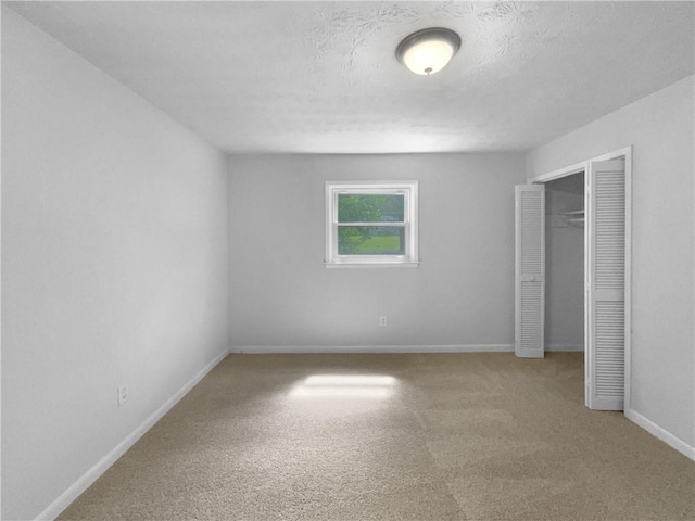 6389 Cumberland Dr, Rex, GA 30273 - unfurnished bedroom with carpet flooring, baseboards, a closet, and a textured ceiling