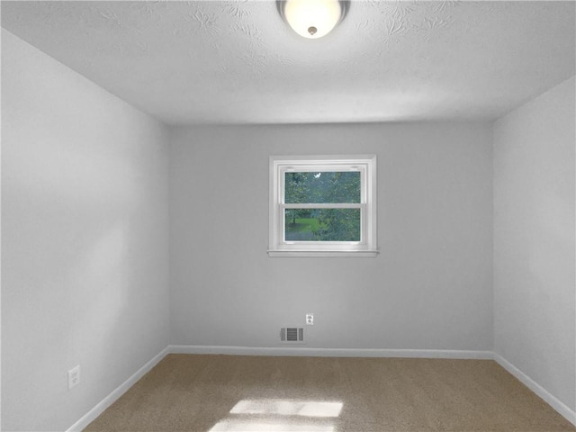 6389 Cumberland Dr, Rex, GA 30273 - spare room featuring carpet floors, a textured ceiling, and baseboards