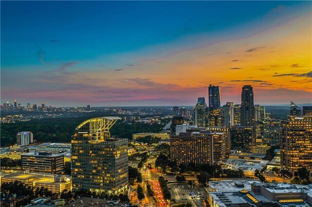 3630 Peachtree Rd NE Unit 3302, Atlanta, GA 30326 - kitchen featuring white cabinets, dark countertops, a sink, decorative backsplash, and expansive windows