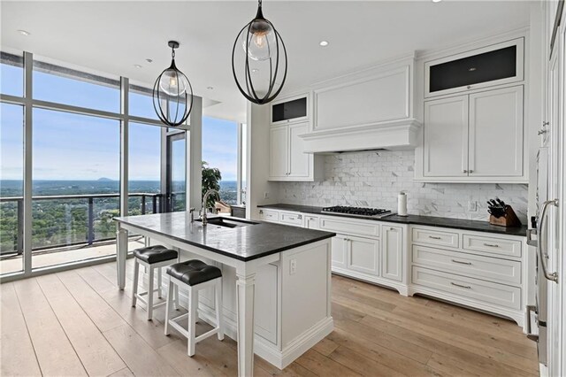 3630 Peachtree Rd NE Unit 3302, Atlanta, GA 30326 - kitchen featuring white cabinetry, appliances with stainless steel finishes, a sink, and tasteful backsplash