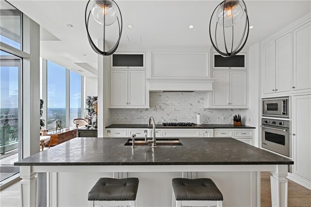 3630 Peachtree Rd NE Unit 3302, Atlanta, GA 30326 - kitchen with a sink, built in appliances, white cabinets, and tasteful backsplash