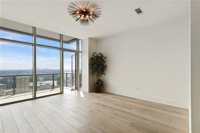 3630 Peachtree Rd NE Unit 3302, Atlanta, GA 30326 - empty room featuring baseboards, light wood-style flooring, and visible vents