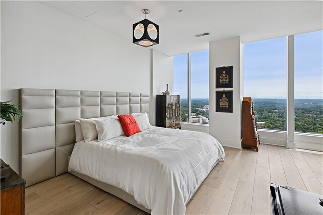 3630 Peachtree Rd NE Unit 3302, Atlanta, GA 30326 - unfurnished room featuring baseboards, a notable chandelier, hardwood / wood-style floors, and visible vents