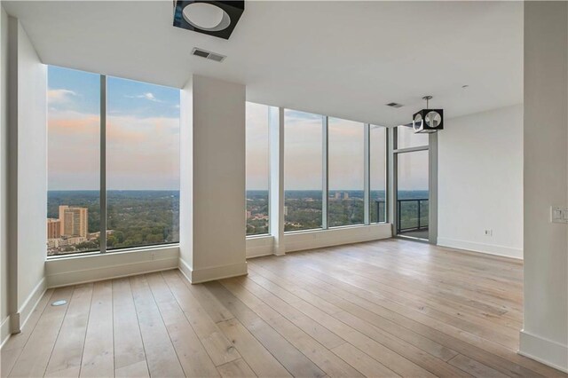 3630 Peachtree Rd NE Unit 3302, Atlanta, GA 30326 - unfurnished room with baseboards, hardwood / wood-style floors, and visible vents