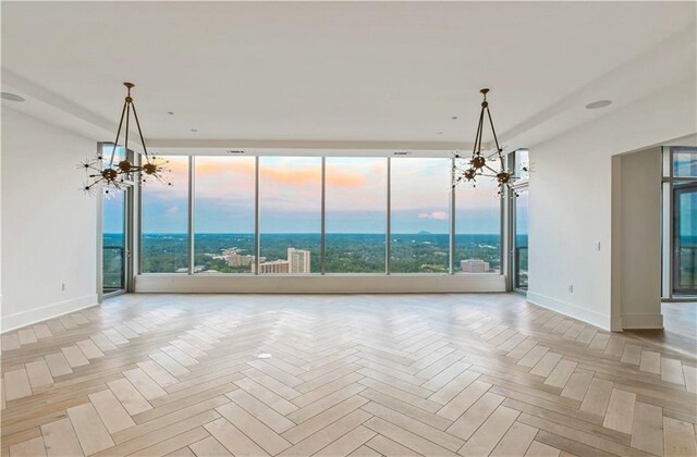 3630 Peachtree Rd NE Unit 3302, Atlanta, GA 30326 - unfurnished dining area with baseboards, a chandelier, floor to ceiling windows, and a sink
