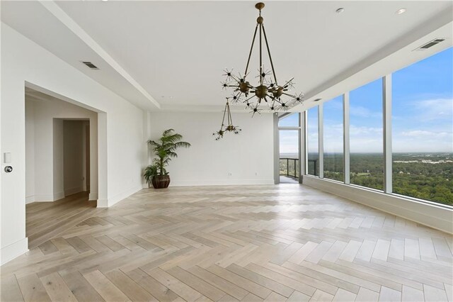 3630 Peachtree Rd NE Unit 3302, Atlanta, GA 30326 - unfurnished living room featuring an inviting chandelier, baseboards, and visible vents