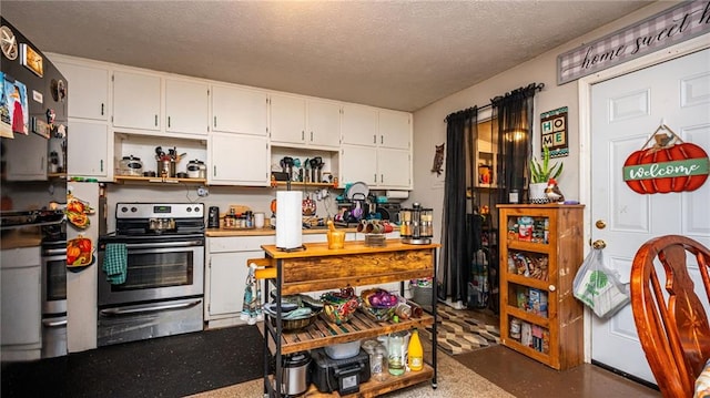 kitchen featuring white cabinets, a textured ceiling, and electric stove