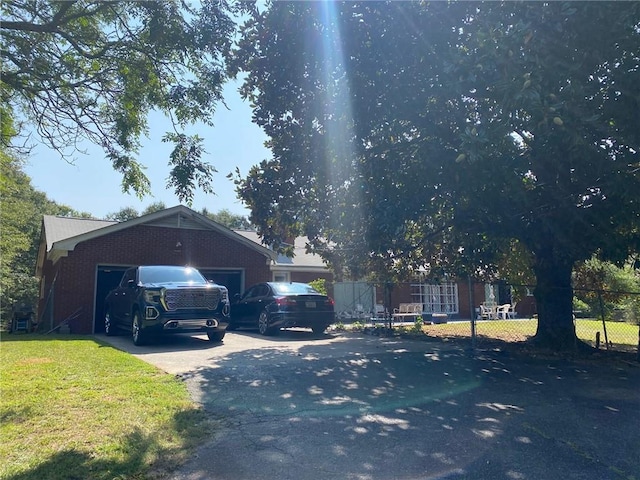 view of side of home with a lawn and a garage