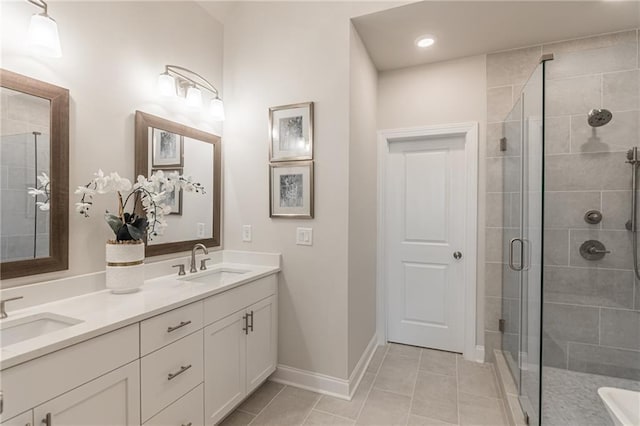 full bathroom with a stall shower, tile patterned flooring, a sink, and double vanity