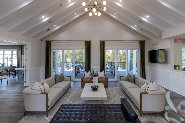 living area with a chandelier, a wealth of natural light, and beamed ceiling