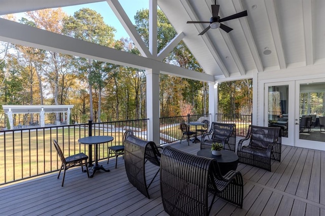 sunroom / solarium featuring lofted ceiling with beams and a ceiling fan