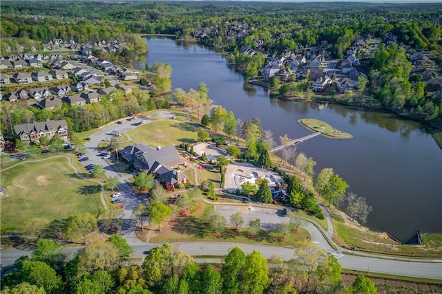 aerial view featuring a view of trees, a residential view, and a water view