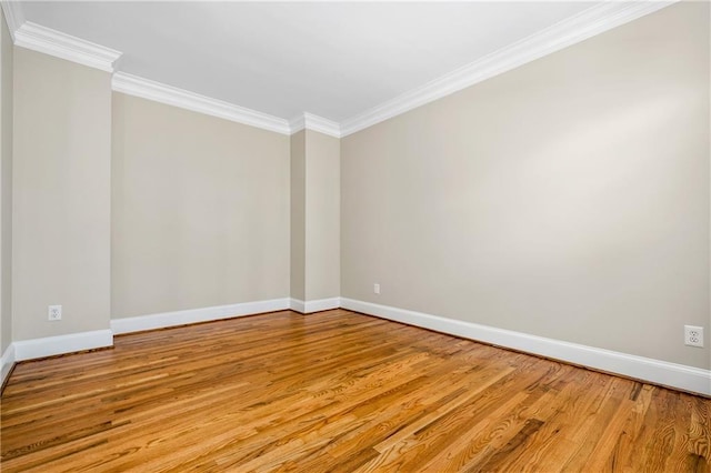 unfurnished room featuring light wood-type flooring and ornamental molding