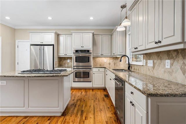 kitchen featuring white cabinetry, sink, a kitchen island, and stainless steel appliances