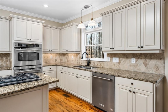 kitchen with white cabinetry, sink, and stainless steel appliances