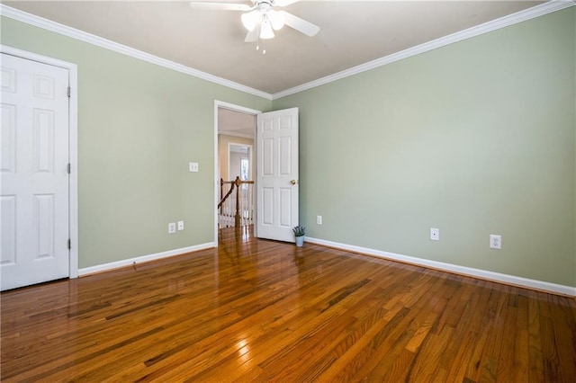 empty room featuring hardwood / wood-style flooring, ceiling fan, and ornamental molding