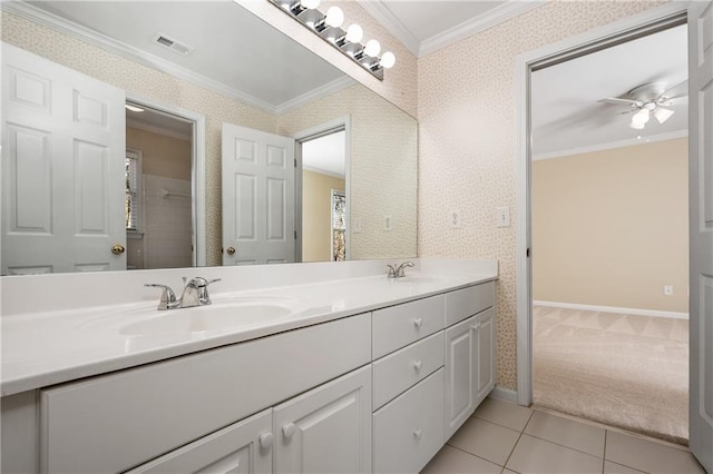 bathroom featuring tile patterned flooring, ceiling fan, crown molding, and vanity