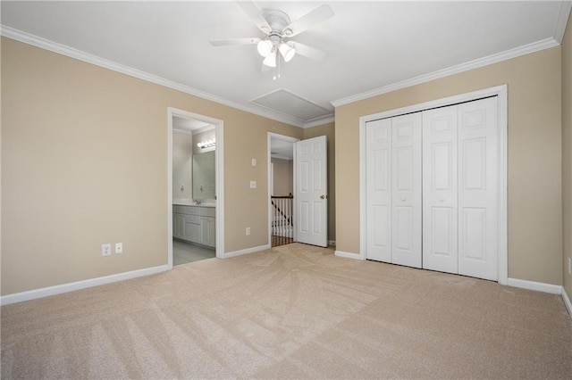 unfurnished bedroom featuring ceiling fan, ornamental molding, ensuite bathroom, and a closet