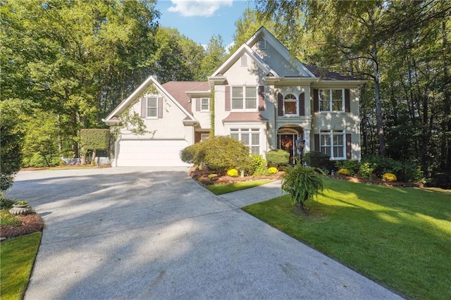 view of front of house featuring a garage and a front lawn