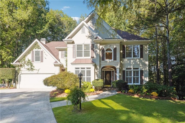 view of front of property with a garage and a front lawn