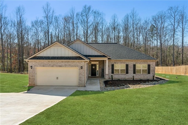 view of front of property with brick siding, a front lawn, fence, a garage, and driveway