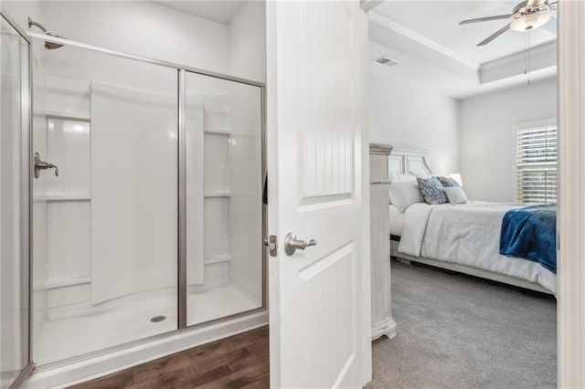 ensuite bathroom featuring a shower stall, crown molding, ceiling fan, ensuite bathroom, and a raised ceiling