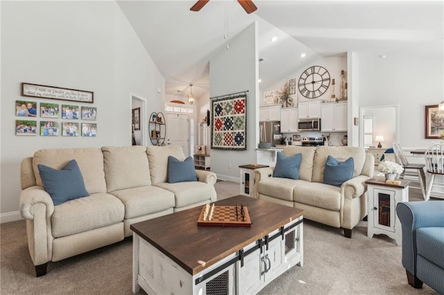 living area featuring a ceiling fan, high vaulted ceiling, and carpet flooring