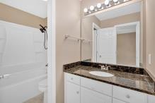 5705 Cannonero Dr, Alpharetta, GA 30005 - unfurnished bedroom with a tray ceiling and wood finished floors