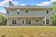 5705 Cannonero Dr, Alpharetta, GA 30005 - unfurnished living room featuring wood finished floors, a chandelier, and a fireplace