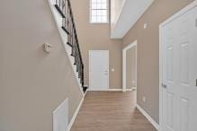 5705 Cannonero Dr, Alpharetta, GA 30005 - entrance foyer with a towering ceiling, wood finished floors, and stairway