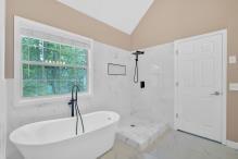 5705 Cannonero Dr, Alpharetta, GA 30005 - kitchen with stainless steel appliances, light wood-style floors, a peninsula, and tasteful backsplash