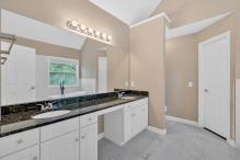 5705 Cannonero Dr, Alpharetta, GA 30005 - kitchen featuring appliances with stainless steel finishes, a peninsula, light wood-type flooring, decorative backsplash, and white cabinetry