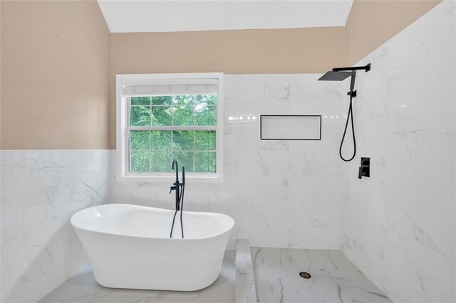 5705 Cannonero Dr, Alpharetta, GA 30005 - full bathroom with marble tiled floors, a freestanding tub, tile walls, a marble finish shower, and wainscoting