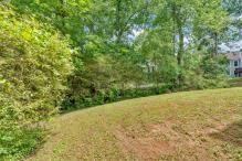 5705 Cannonero Dr, Alpharetta, GA 30005 - view of green lawn with a patio