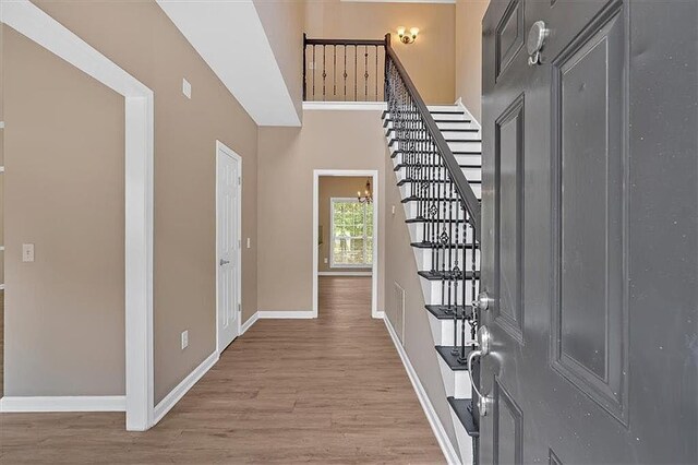 5705 Cannonero Dr, Alpharetta, GA 30005 - unfurnished living room featuring a chandelier, light wood-type flooring, a ceiling fan, and a fireplace