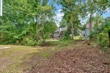 5705 Cannonero Dr, Alpharetta, GA 30005 - kitchen with stainless steel appliances, white cabinetry, and healthy amount of natural light