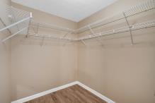 5705 Cannonero Dr, Alpharetta, GA 30005 - unfurnished living room featuring a raised ceiling, ceiling fan, wood finished floors, and a tiled fireplace