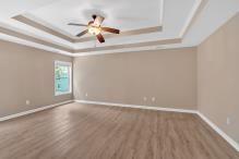 5705 Cannonero Dr, Alpharetta, GA 30005 - unfurnished dining area with a chandelier, a tray ceiling, and wood finished floors
