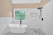 5705 Cannonero Dr, Alpharetta, GA 30005 - full bathroom with tile walls, a freestanding tub, and a shower