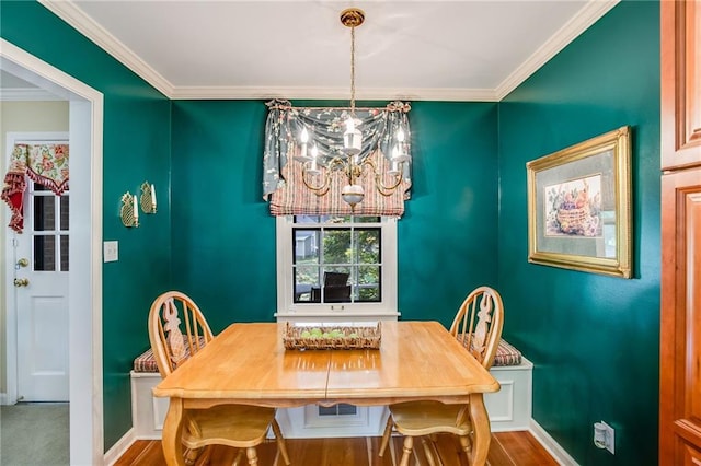 dining room with an inviting chandelier and ornamental molding