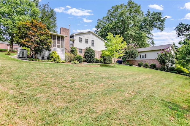 view of yard featuring a sunroom