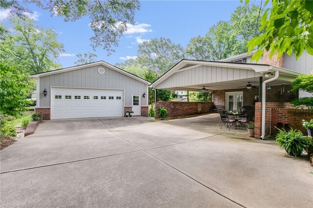 view of front of home with french doors, ceiling fan, a garage, and a patio area